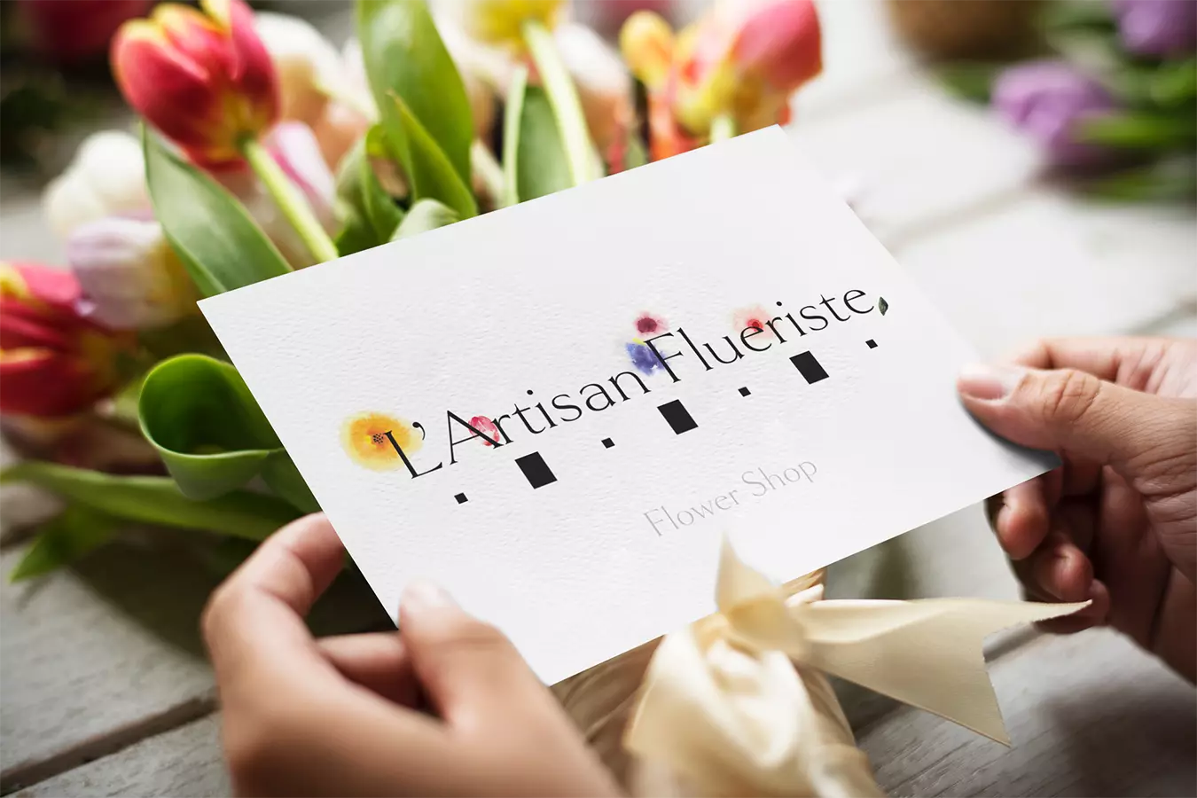L'Artisan Flueriste logo on card.